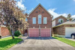 Front exterior of 3364 Ingram Rd., Mississauga featuring a two-storey brick home with double garage and landscaped front yard.