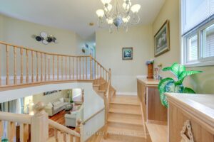 Upper landing overlooking the foyer with hardwood flooring and bright natural light.