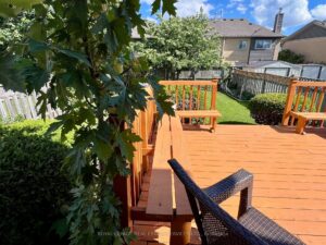 Alternate view of the backyard deck featuring built-in seating and access to the fully fenced backyard at 3364 Ingram Rd.