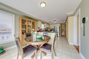 Open breakfast area connecting to the kitchen with sliding doors to the backyard deck.