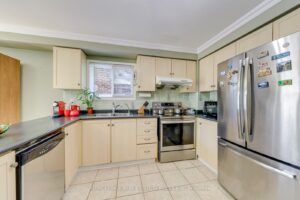 Bright kitchen featuring wraparound countertops, stainless steel appliances and generous storage.