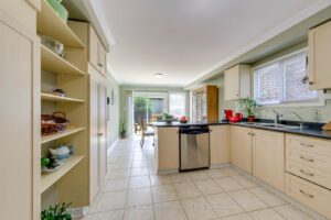 Kitchen view showing breakfast area, peninsula seating space and walkout to the backyard deck.