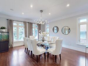 Spacious dining room with hardwood flooring and abundant natural light.