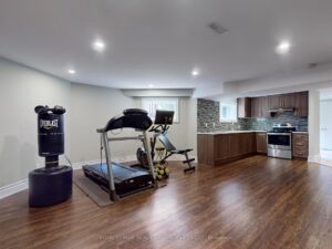 Finished basement featuring a home gym, recreation area, and wet bar.
