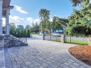 Expansive interlock driveway leading to the detached luxury home and triple garage.