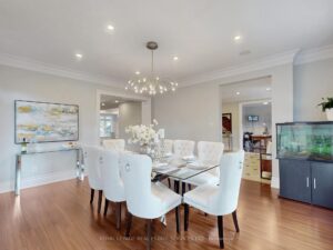 Dining room with contemporary lighting and view toward the adjoining living spaces.