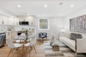 Legal basement apartment with open-concept kitchen, dining area and comfortable living room.