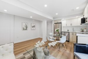 Open-concept legal basement apartment featuring modern kitchen, dining space and spacious living area.