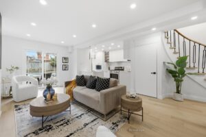 Open-concept living room with sliding patio doors, contemporary furnishings and seamless connection to the kitchen.