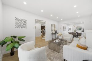 Elegant formal living room with hardwood floors, modern furnishings and open access to the dining room.