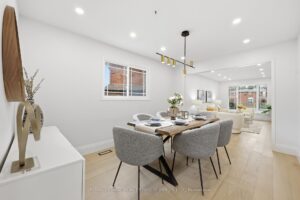 Spacious formal dining room with designer lighting, hardwood flooring and contemporary finishes.