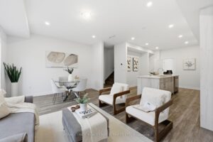 Spacious open-concept living room flowing into the dining area and modern kitchen with center island.