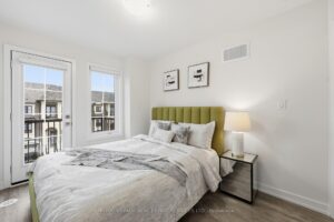Bright bedroom with private balcony access, large windows and stylish contemporary finishes.