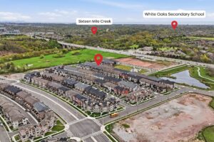 Aerial view showing the home's proximity to Sixteen Mile Creek, White Oaks Secondary School and nearby amenities.