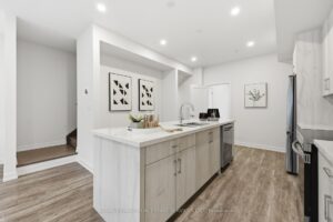 Spacious chef-inspired kitchen featuring quartz countertops, generous cabinetry and a large center island.