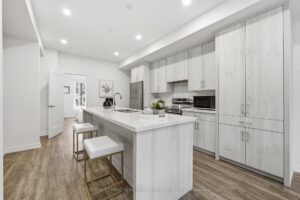 Modern kitchen with expansive island, open-concept design and easy access to the main living areas.