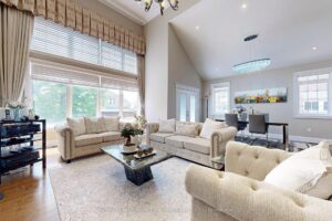 Rear exterior featuring a private backyard with covered patio, swimming pool, and landscaped gardens.