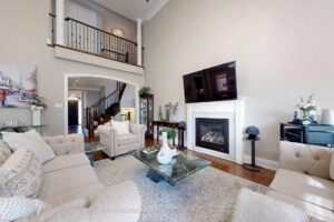 Two-storey great room with gas fireplace, open staircase, and upper-level overlook.