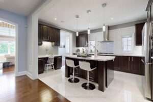 Gourmet kitchen with large centre island, breakfast bar, and custom cabinetry.