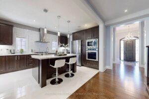 Bright chef's kitchen with premium stainless steel appliances and oversized island.