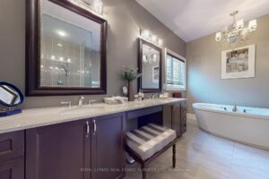 Spa-inspired primary ensuite with double vanity, soaker tub, and contemporary finishes.