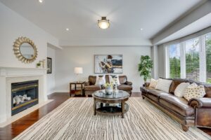 Family room at 2249 Glazebrook, Mississauga, featuring hardwood flooring, a gas fireplace, and oversized bay windows.