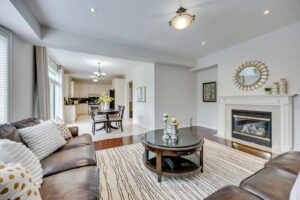 Bright family room at 2249 Glazebrook, Mississauga, showcasing a gas fireplace and open-concept layout.