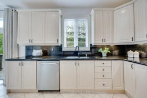 Well-appointed kitchen at 2249 Glazebrook, Mississauga, with granite countertops, ample cabinetry, and a large window above the sink.