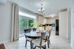 Bright breakfast area at 2249 Glazebrook, Mississauga, with walkout access to the backyard deck and open-concept kitchen.