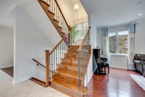 Elegant hardwood staircase at 2249 Glazebrook, Mississauga, featuring iron pickets and an open foyer design.