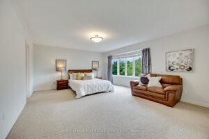 Spacious primary bedroom at 2249 Glazebrook, Mississauga, featuring a large bay window, sitting area, and abundant natural light.