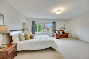 Expansive primary bedroom at 2249 Glazebrook, Mississauga, featuring a bay window, sitting area, and plush carpeting.