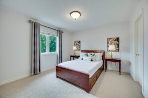 Bright secondary bedroom at 2249 Glazebrook, Mississauga, featuring a large window, spacious layout, and ample closet space.