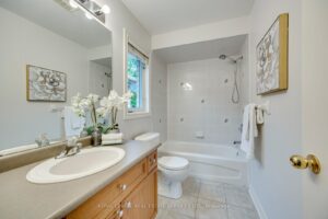 Full bathroom at 2249 Glazebrook, Mississauga, featuring a vanity, bathtub with shower, and bright natural light.