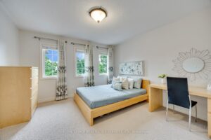 Comfortable bedroom at 2249 Glazebrook, Mississauga, offering multiple windows, generous space, and a built-in desk.