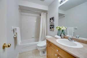 Well-maintained full bathroom at 2249 Glazebrook, Mississauga, featuring a bathtub, shower, and vanity with storage.