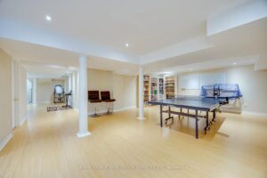 Finished recreation room at 2249 Glazebrook, Mississauga, featuring a spacious open layout, games area, and home gym space.