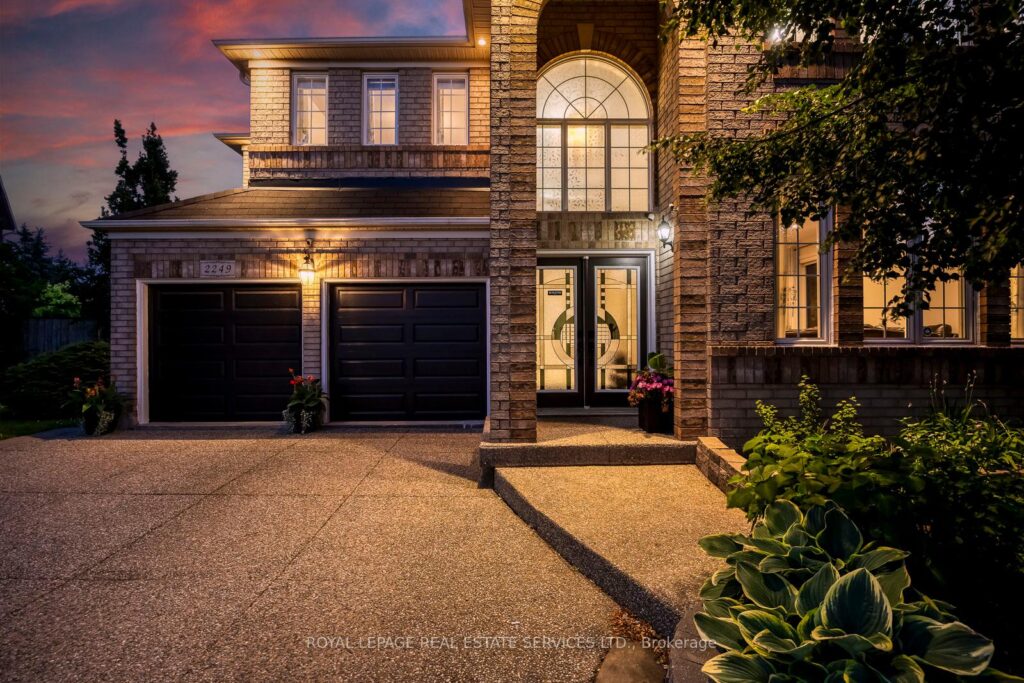 Twilight exterior of 2249 Glazebrook, Mississauga, highlighting the elegant façade and illuminated grand entrance.