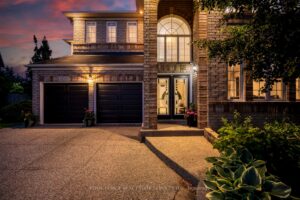 Twilight exterior of 2249 Glazebrook, Mississauga, highlighting the elegant façade and illuminated grand entrance.