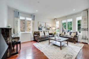 Bright formal living room at 2249 Glazebrook, Mississauga, with hardwood flooring, oversized windows, and abundant natural light.
