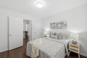 Spacious bedroom with hardwood flooring.