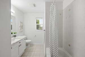Four-piece bathroom with vanity and bathtub.