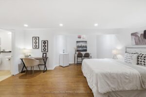 Finished basement recreation room with wood-look flooring and open-concept layout.