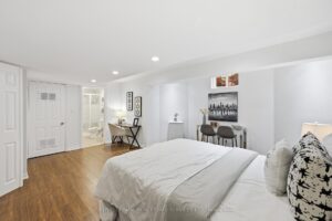 Spacious finished basement with bedroom space, and recessed lighting.