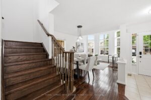 Main floor featuring the staircase, dining room, and open-concept layout.