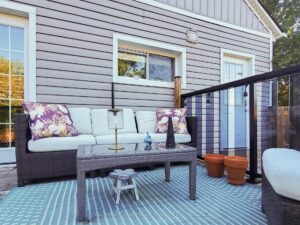 Private backyard deck with outdoor seating and low-maintenance landscaping.