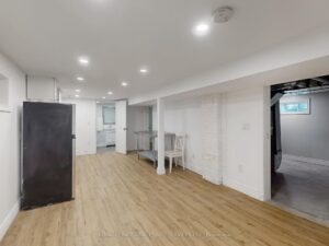 Spacious finished basement with open layout, modern flooring, and flexible living space.