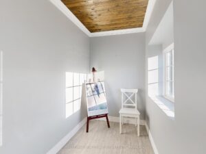 Bright front foyer with decorative wood ceiling and welcoming entryway.