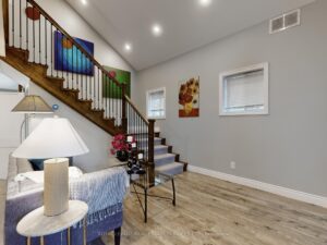 Open-concept living room with staircase, modern finishes, and spacious layout.