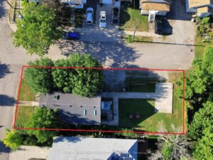 Aerial property view with lot boundaries highlighted to show the home's footprint.